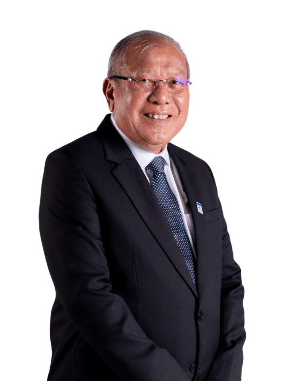 Elderly man in suit and tie, smiling warmly with glasses and lapel pin, set against black background, conveying professionalism.