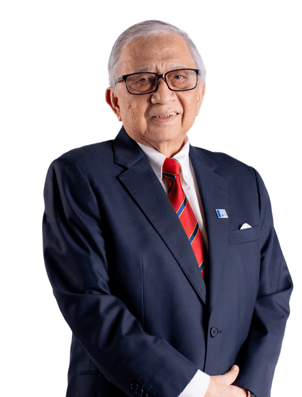 Elderly man in dark suit and red striped tie, wearing glasses, stands confidently against black background, exuding professionalism.