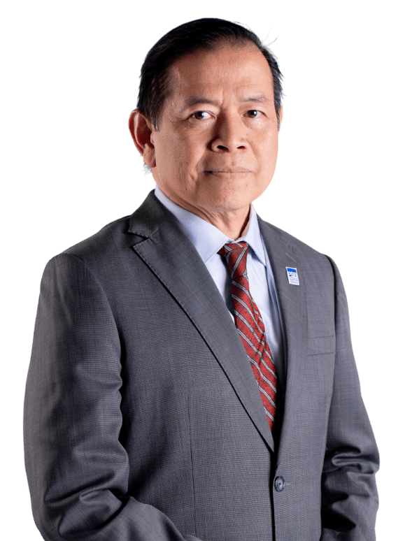Man in grey suit and red striped tie stands confidently against black background, conveying professionalism with a serious expression.