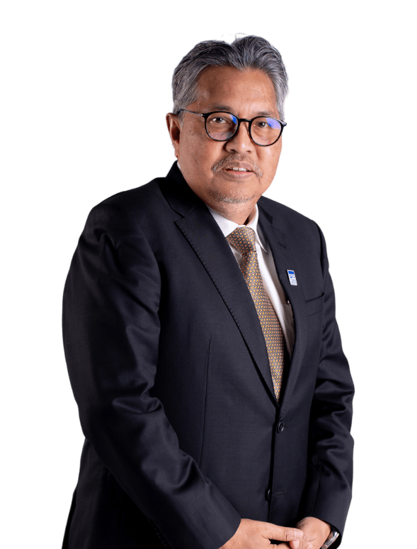 Elderly man in a suit with glasses stands against a black background, exuding a formal and confident demeanor, hands clasped in front.