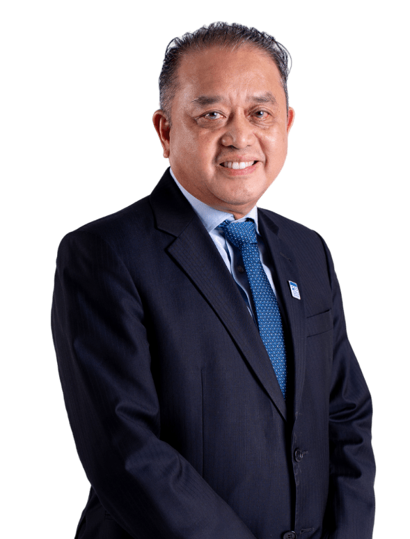 Smiling man in dark suit and blue tie with name badge, set against black background, exuding professionalism and confidence.